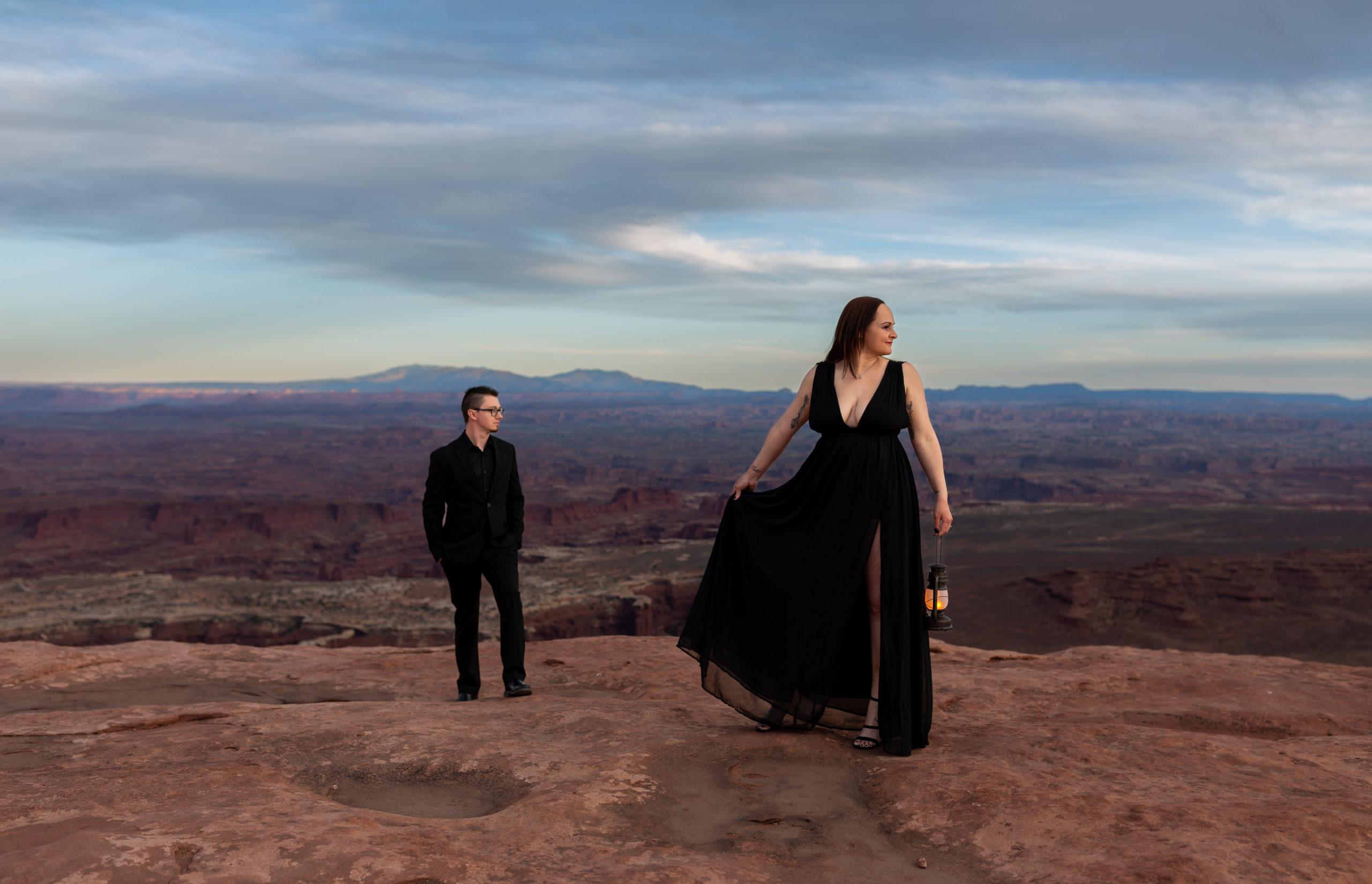 Couple dressed in black standing at the grand view point overlook in Canyonlands National Park in Moab, Utah