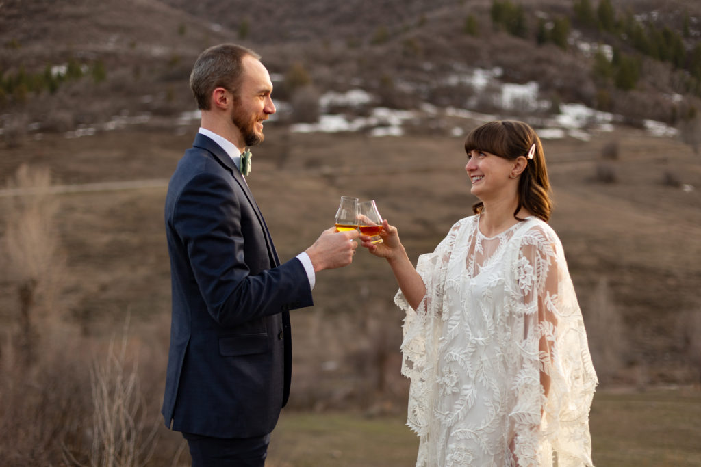 Mountain Elopement Locations Near Salt Lake  - Couple toasting marriage with whiskey in the mountains