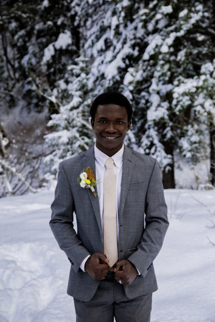 Groom by himself facing the camera and smiling