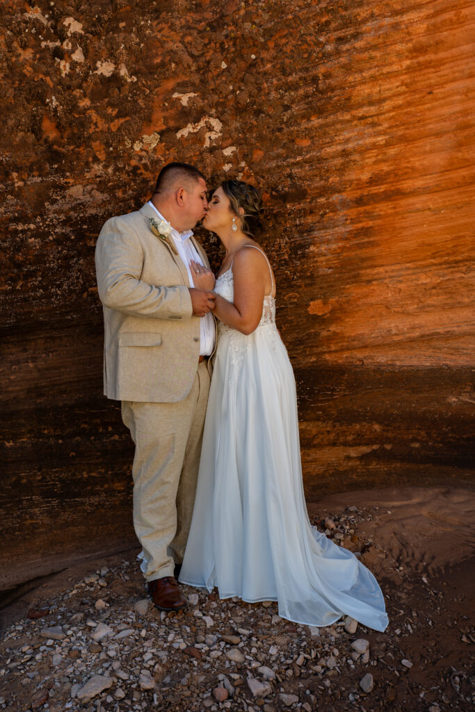 Bride and groom in a red rock slot canyon in Zion National Park in Utah