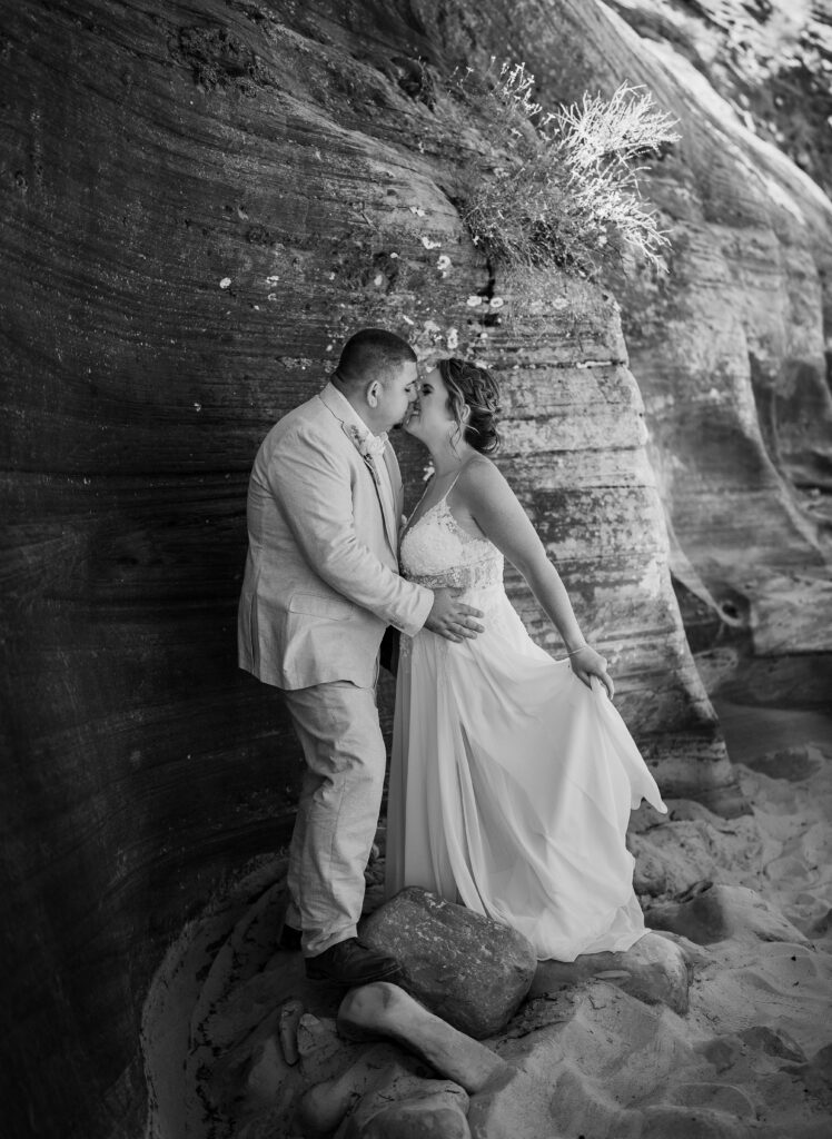 Bride and groom in a red rock slot canyon in Zion National Park in Utah