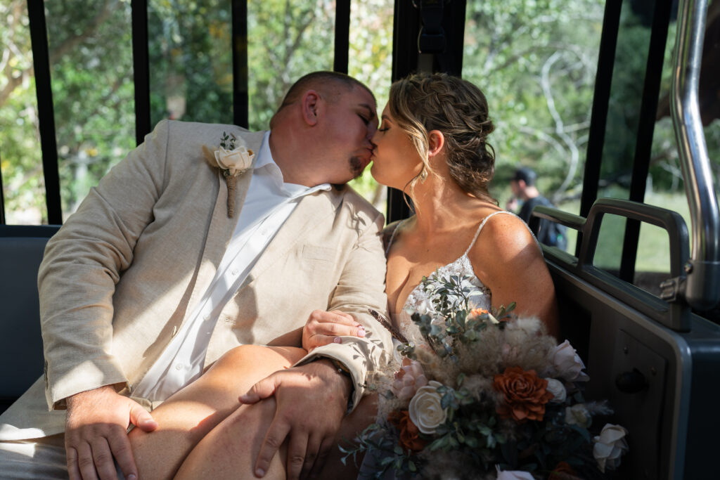 Bride and groom kissing on the shuttle bus at Zion National Park in Utah