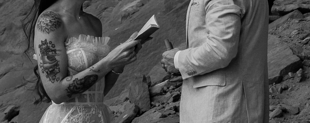 Cropped photo in black and white of bride reading her vows to the groom in Moab, Utah