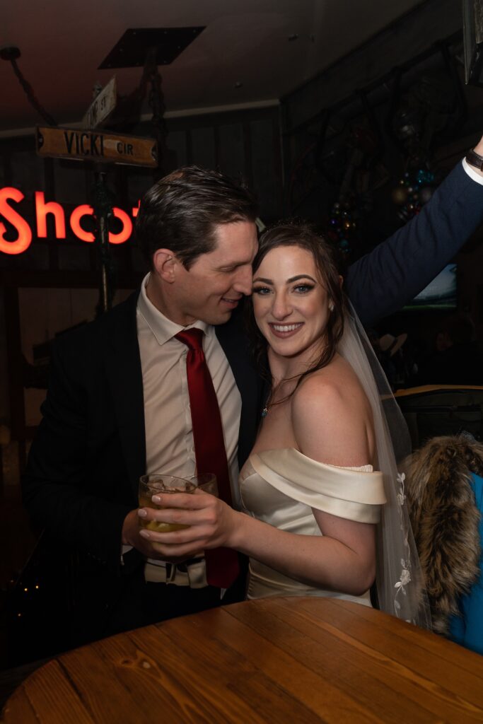 Bride and groom celebrating their elopement at a bar in Park CIty, Utah